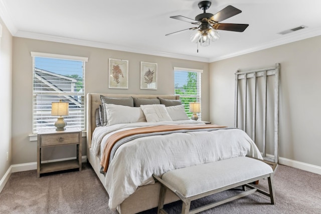 bedroom featuring visible vents, baseboards, crown molding, and light carpet
