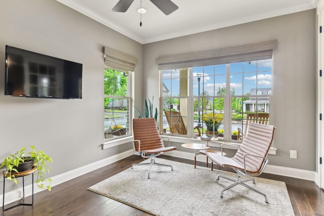 sitting room with crown molding, baseboards, ceiling fan, and hardwood / wood-style floors