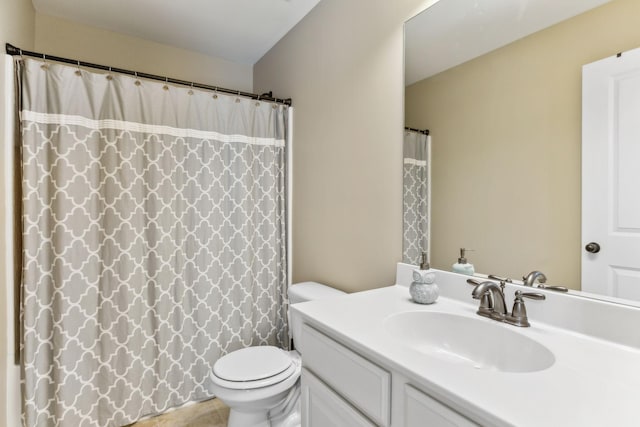 bathroom with vanity, toilet, and curtained shower