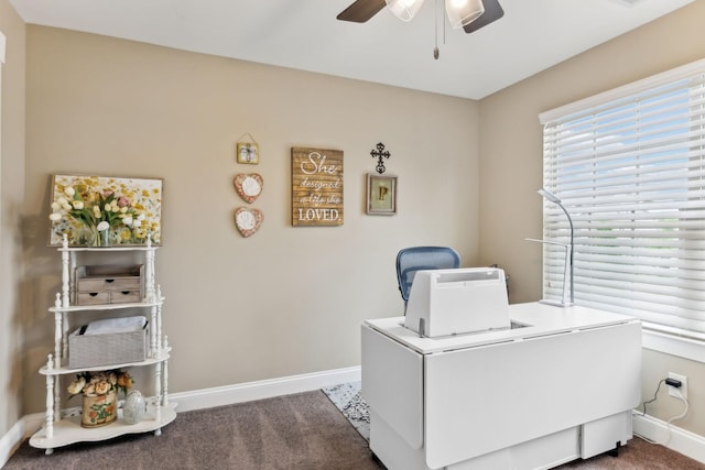 office space with baseboards, a ceiling fan, and carpet