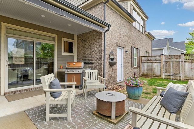 view of patio featuring fence and area for grilling