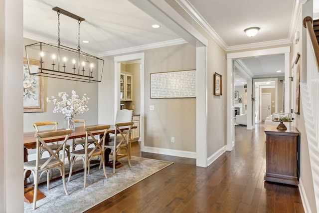 dining space with baseboards, ornamental molding, and dark wood-type flooring
