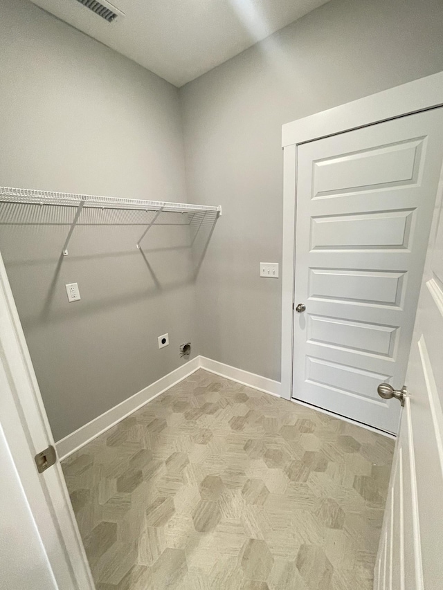 laundry area with baseboards, laundry area, electric dryer hookup, and visible vents