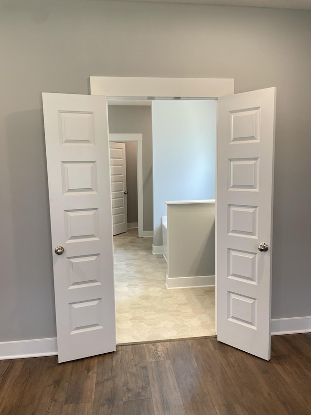 interior space with baseboards and wood finished floors