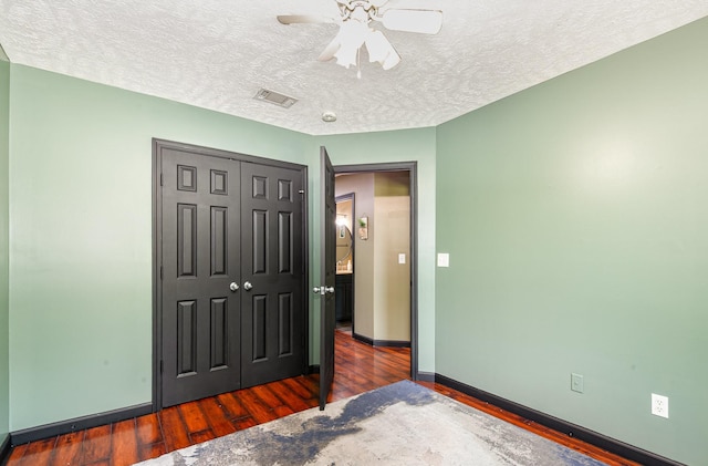 1904 Portway Rd, Spring Hill, TN 37174 - unfurnished bedroom with wood finished floors, a textured ceiling, a closet, baseboards, and ceiling fan