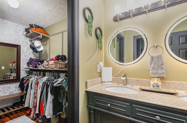 1904 Portway Rd, Spring Hill, TN 37174 - bathroom featuring double vanity, wood finished floors, and wallpapered walls