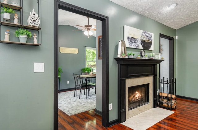 1904 Portway Rd, Spring Hill, TN 37174 - detailed view of a textured ceiling, a premium fireplace, wood finished floors, baseboards, and a ceiling fan