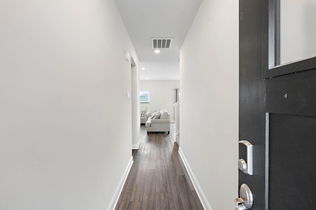hallway featuring recessed lighting, baseboards, dark wood finished floors, and visible vents