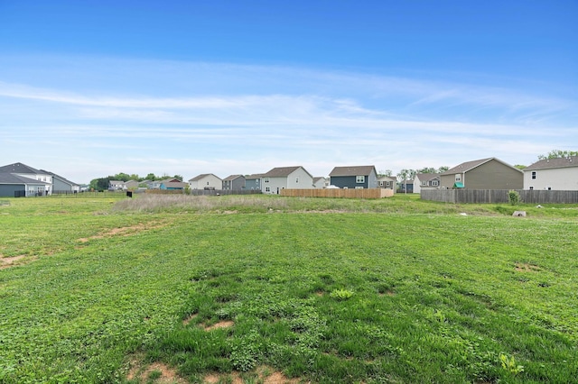 view of yard with fence and a residential view
