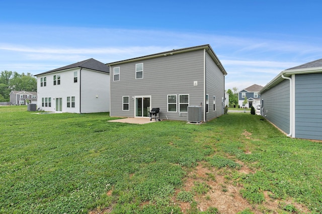 back of house featuring a yard, a patio area, and central air condition unit