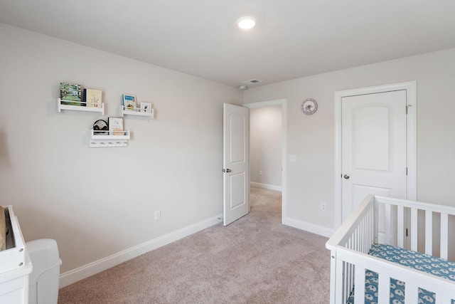 bedroom with baseboards and light carpet