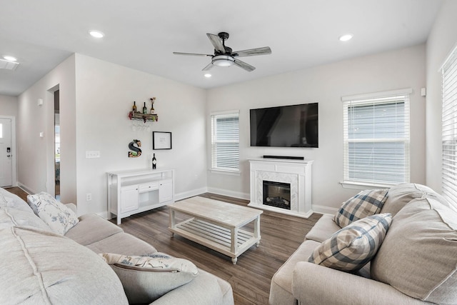 living room with a ceiling fan, baseboards, recessed lighting, and wood finished floors