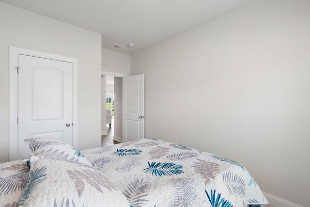 bedroom featuring visible vents and baseboards