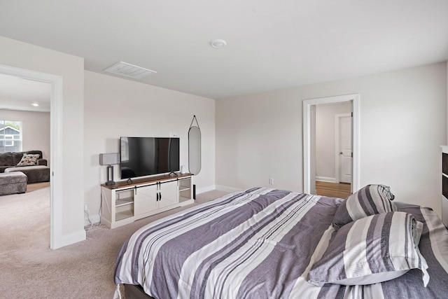 bedroom with visible vents, carpet, and baseboards