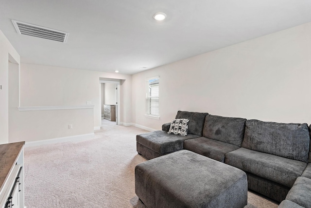 living room featuring recessed lighting, baseboards, visible vents, and light carpet