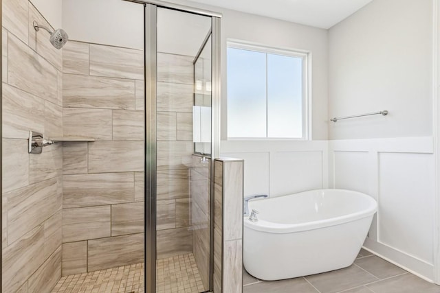 7205 Lake Rd, Fairview, TN 37062 - full bathroom with a stall shower, a freestanding bath, a decorative wall, tile patterned flooring, and a wainscoted wall