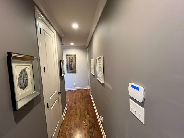 hall featuring recessed lighting, baseboards, and dark wood-type flooring