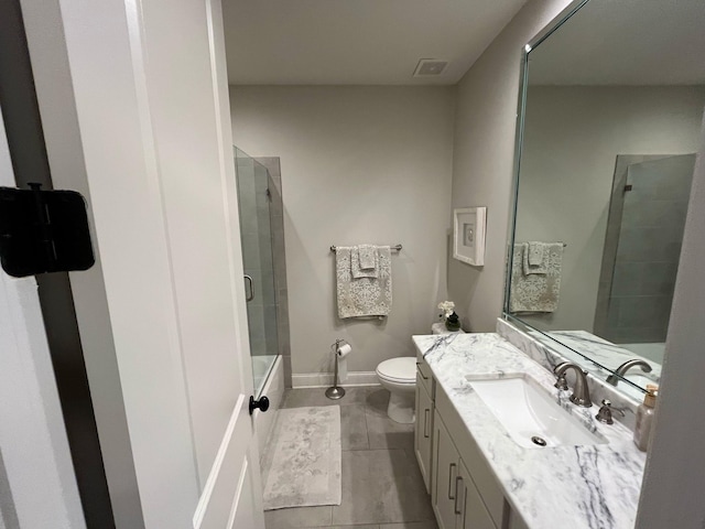 full bath with shower / bath combination with glass door, tile patterned flooring, vanity, toilet, and visible vents