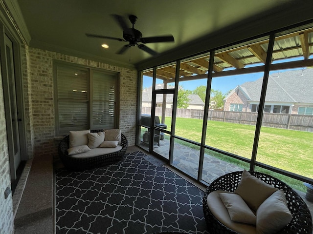 sunroom / solarium with a ceiling fan