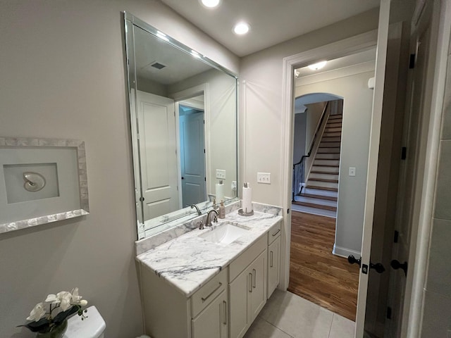 bathroom featuring vanity, tile patterned flooring, baseboards, and recessed lighting