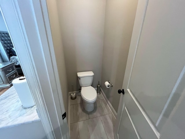 bathroom with tile patterned flooring and toilet