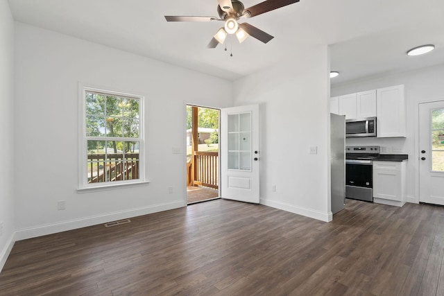 795 Lowery Ln, Mcminnville, TN 37110 - unfurnished living room featuring dark wood-style flooring, ceiling fan, visible vents, and a wealth of natural light