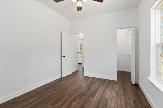 795 Lowery Ln, Mcminnville, TN 37110 - unfurnished bedroom featuring baseboards, dark wood-style flooring, a spacious closet, and a closet
