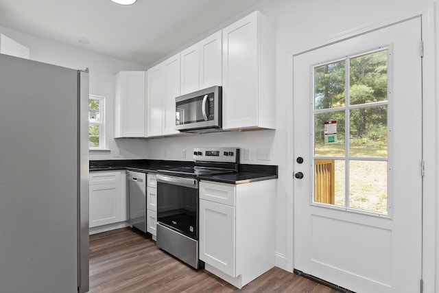 795 Lowery Ln, Mcminnville, TN 37110 - kitchen with dark countertops, appliances with stainless steel finishes, white cabinetry, and dark wood-type flooring
