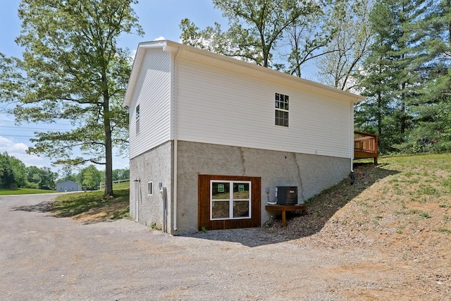795 Lowery Ln, Mcminnville, TN 37110 - back of property with a wooden deck, central AC unit, and stucco siding