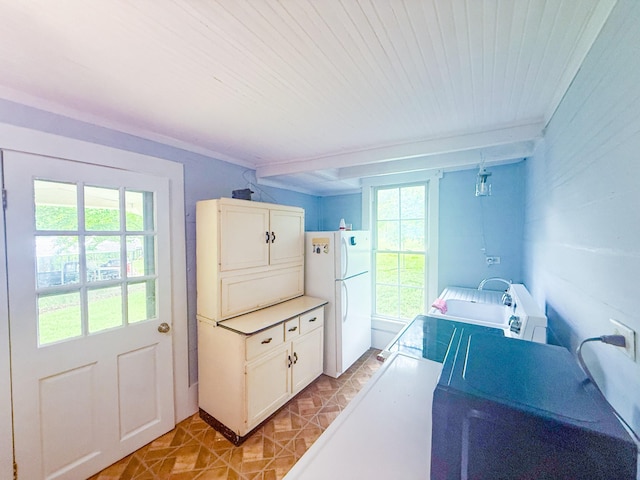 mudroom featuring light tile patterned flooring, washer / dryer, and a wealth of natural light