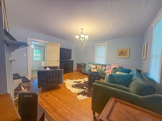 living room with wooden ceiling, wood finished floors, and a chandelier