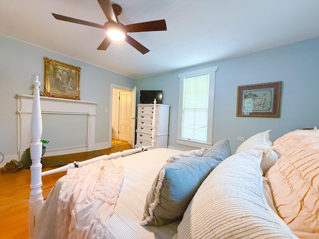 bedroom with a ceiling fan and wood finished floors