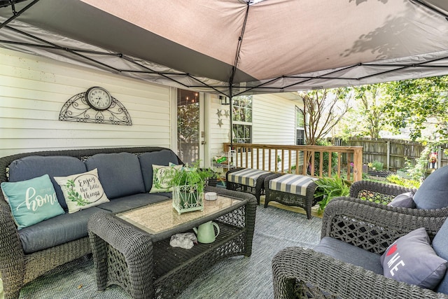 wooden deck featuring an outdoor living space and fence