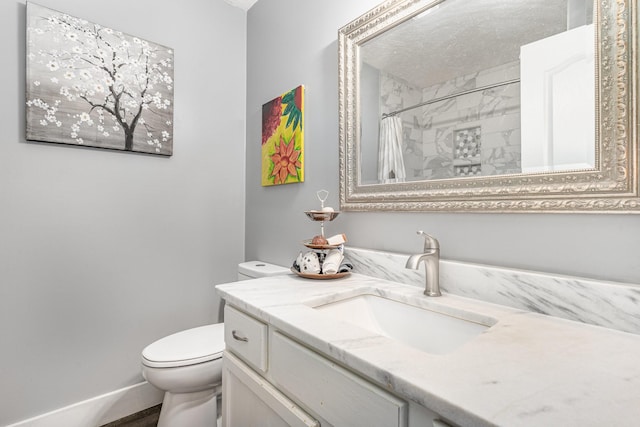bathroom featuring toilet, curtained shower, and vanity