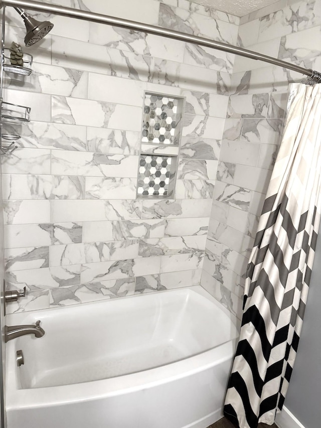 bathroom featuring shower / bathtub combination with curtain