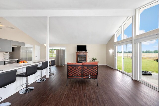 401 Longview St, Athens, AL 35611 - living room featuring beam ceiling, high vaulted ceiling, dark wood finished floors, a glass covered fireplace, and baseboards