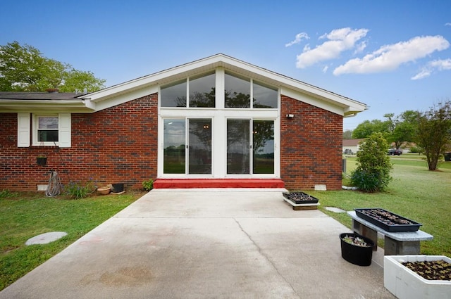 401 Longview St, Athens, AL 35611 - back of house with a lawn, brick siding, and a patio area