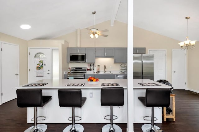 401 Longview St, Athens, AL 35611 - kitchen featuring gray cabinetry, light countertops, high vaulted ceiling, ceiling fan with notable chandelier, and stainless steel appliances