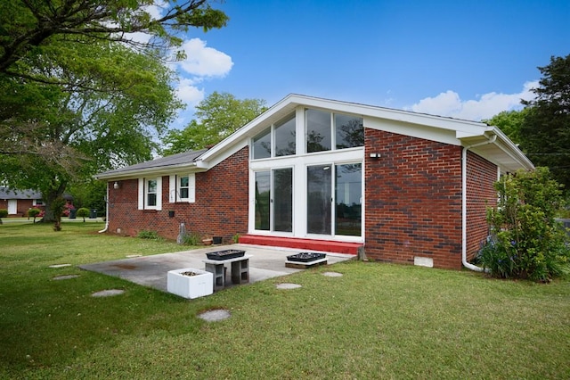 401 Longview St, Athens, AL 35611 - back of house with a yard, brick siding, a fire pit, and a patio area