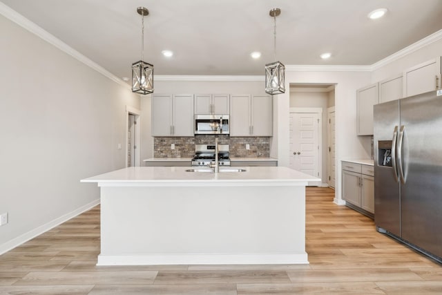 1010 Baltusrol Ln, Lebanon, TN 37087 - kitchen with ornamental molding, a kitchen island with sink, light countertops, backsplash, and stainless steel appliances
