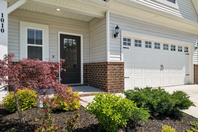 1010 Baltusrol Ln, Lebanon, TN 37087 - view of exterior entry with brick siding, a garage, and concrete driveway
