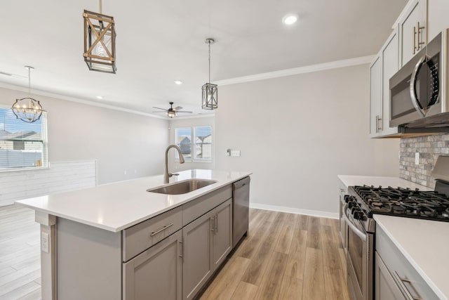 1010 Baltusrol Ln, Lebanon, TN 37087 - kitchen featuring gray cabinets, crown molding, a sink, ceiling fan with notable chandelier, and stainless steel appliances
