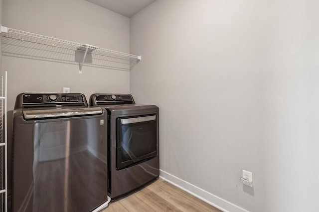 1010 Baltusrol Ln, Lebanon, TN 37087 - clothes washing area with baseboards, laundry area, light wood finished floors, and washer and clothes dryer
