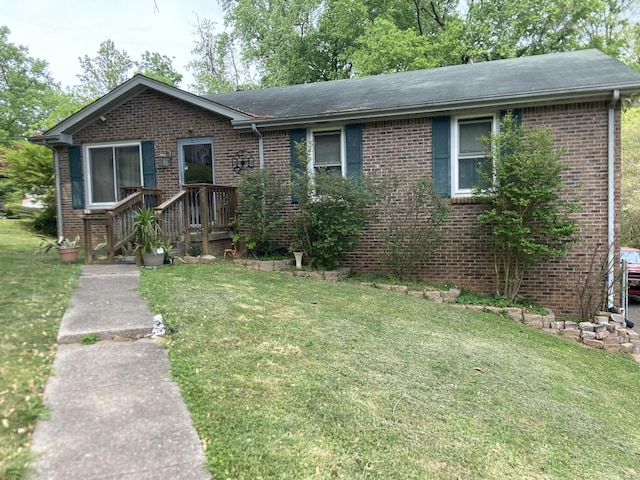 ranch-style house with a front lawn and brick siding