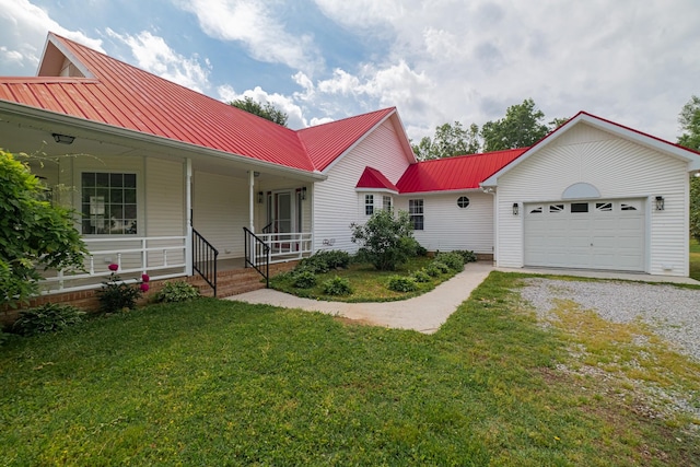 160 Robert E Lee Dr, Manchester, TN 37355 - view of front of property with covered porch, driveway, metal roof, a front lawn, and an attached garage