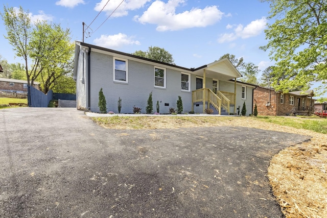 view of front facade with driveway and brick siding