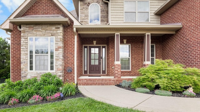 doorway to property with stone siding and brick siding