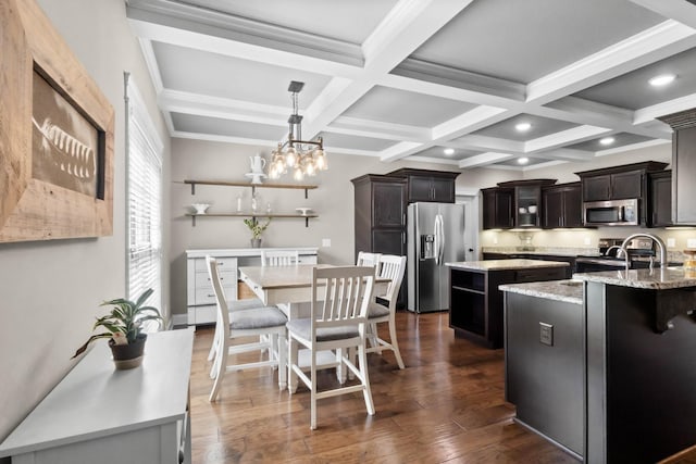 kitchen featuring stainless steel appliances, coffered ceiling, a kitchen island, beamed ceiling, and dark wood-style flooring