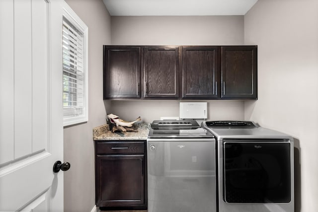 laundry area featuring cabinet space, washer and clothes dryer, and baseboards