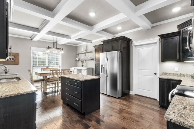 kitchen with stainless steel fridge, a sink, dark wood finished floors, coffered ceiling, and beam ceiling